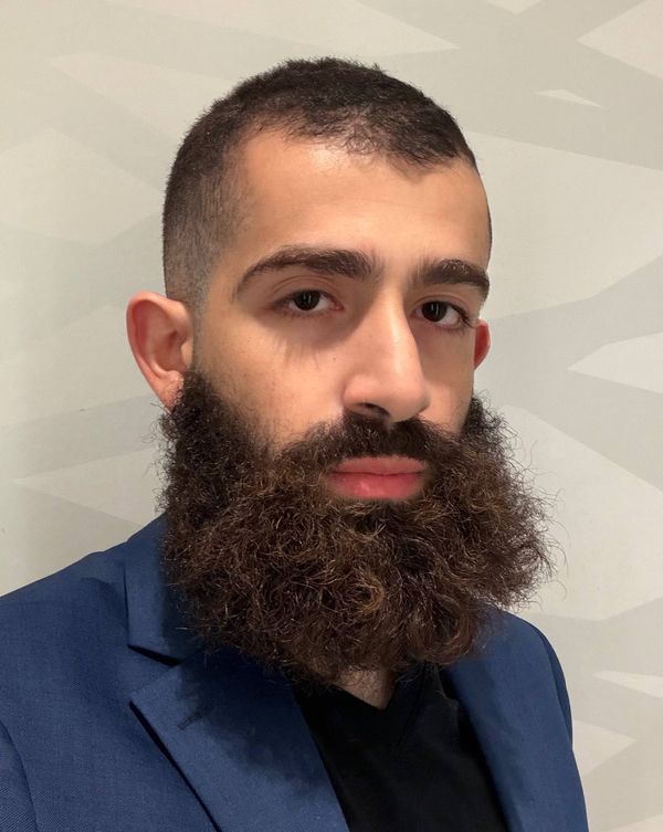 Ahmad Abu-Hattab in a navy suit.